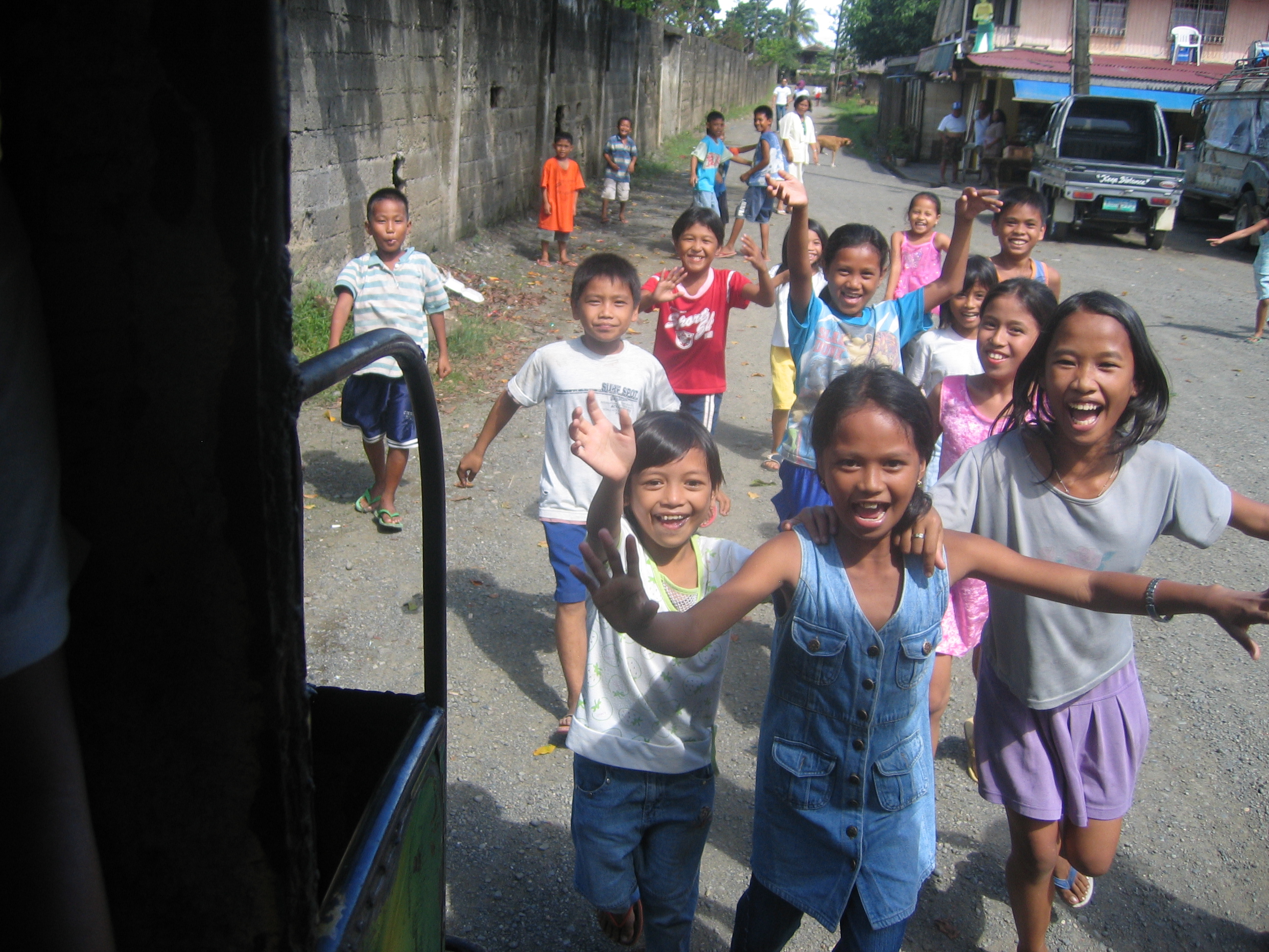 Filipino Children say goodbye to departing visitors.